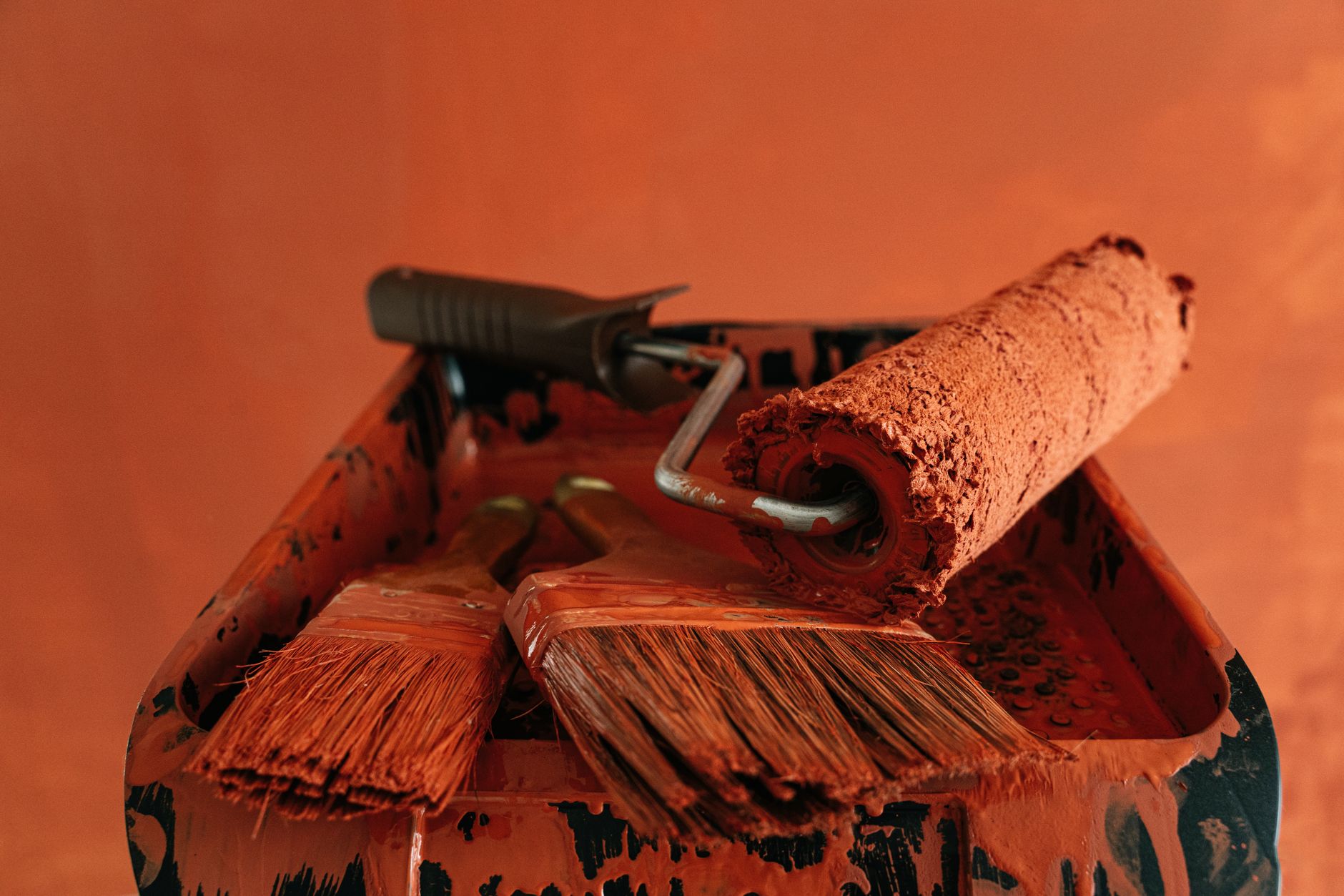 Orange paint tools in a messy tray, perfect for renovation themes. — Do It Yourself - Steps to make the need for Your Home Gr