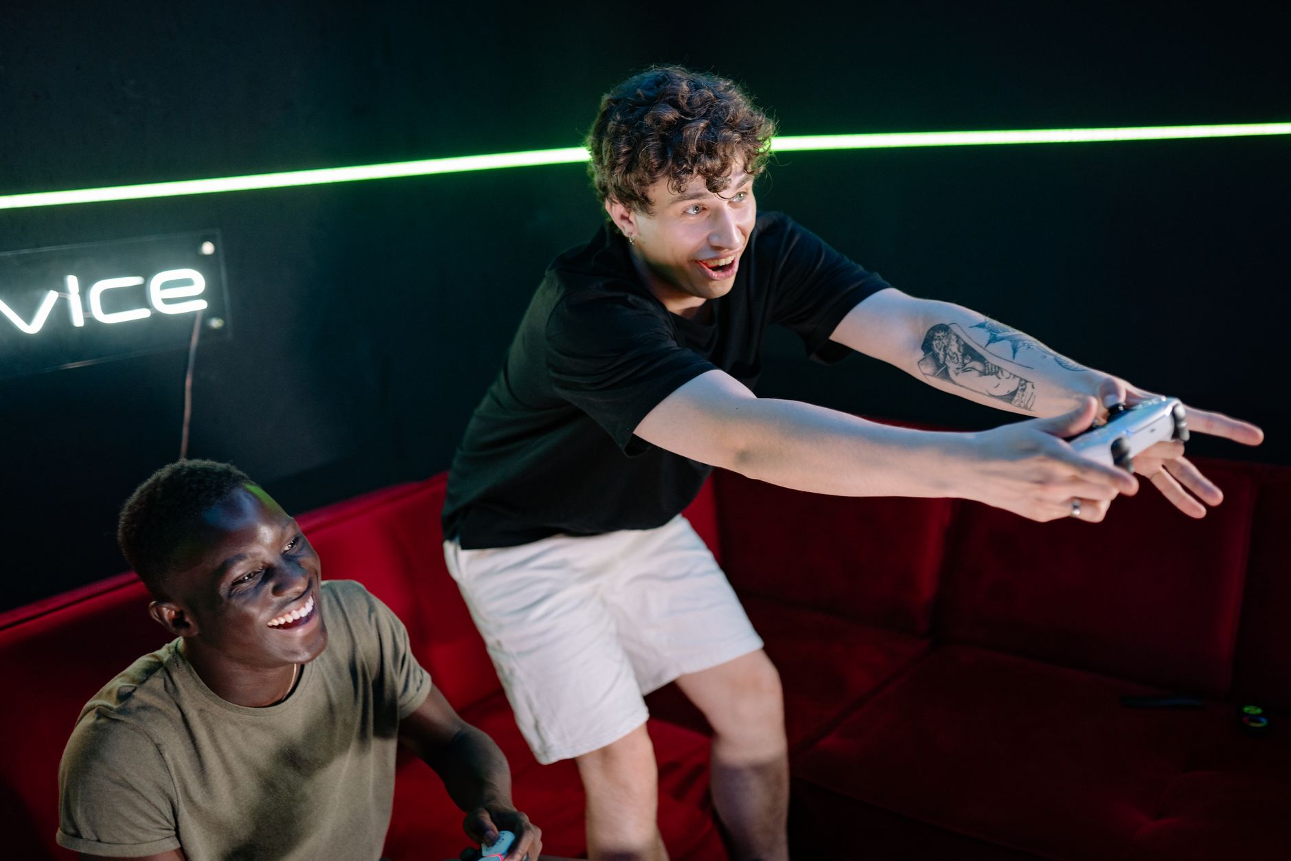 Two young men having fun playing video games in a cozy indoor setting. — Easy Slot Games - Tips For Winning Big