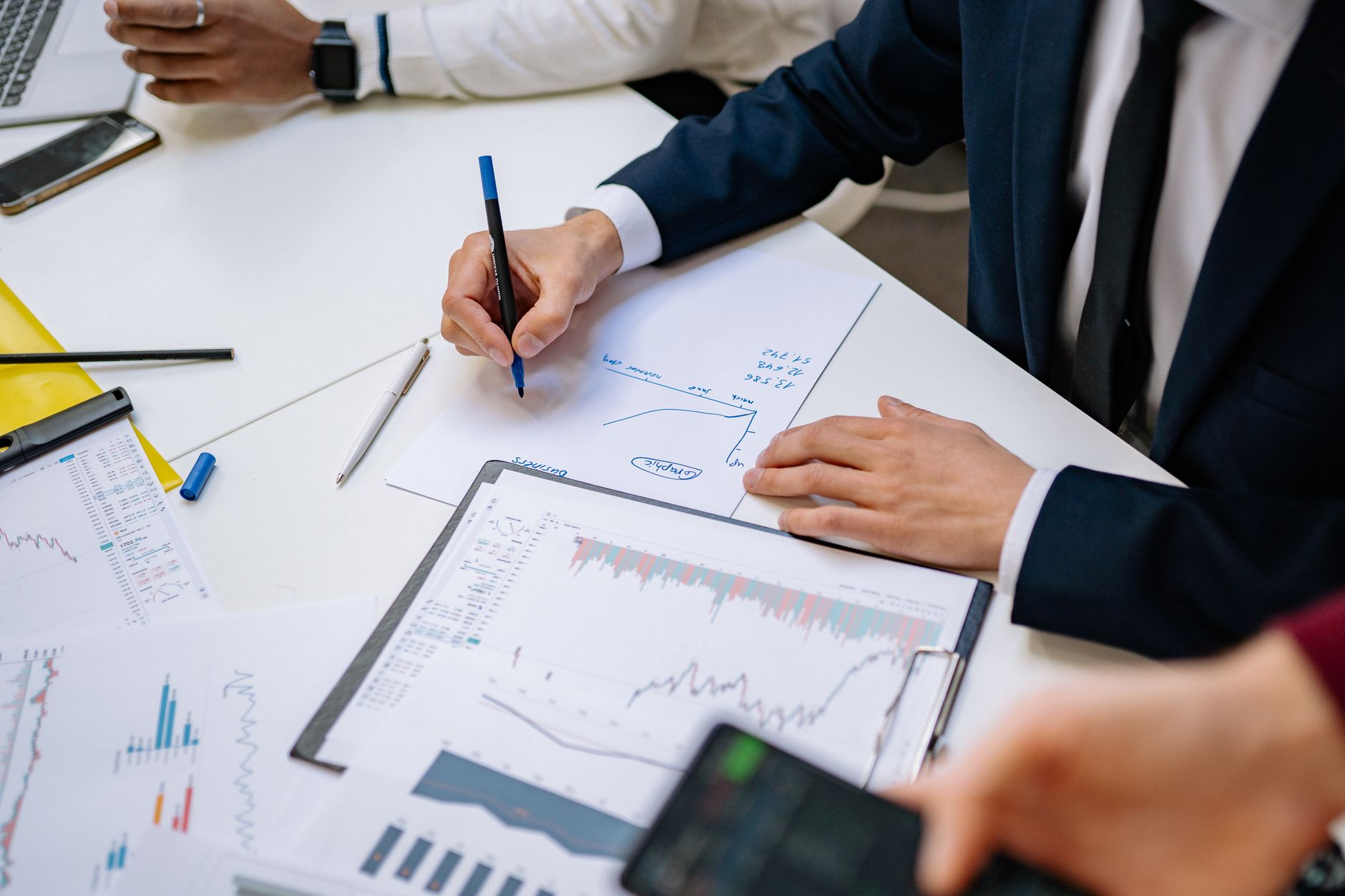 Professionals analyzing financial charts in a corporate setting. — Enjoy Intimate Experiences with High-Tech Sex Toys