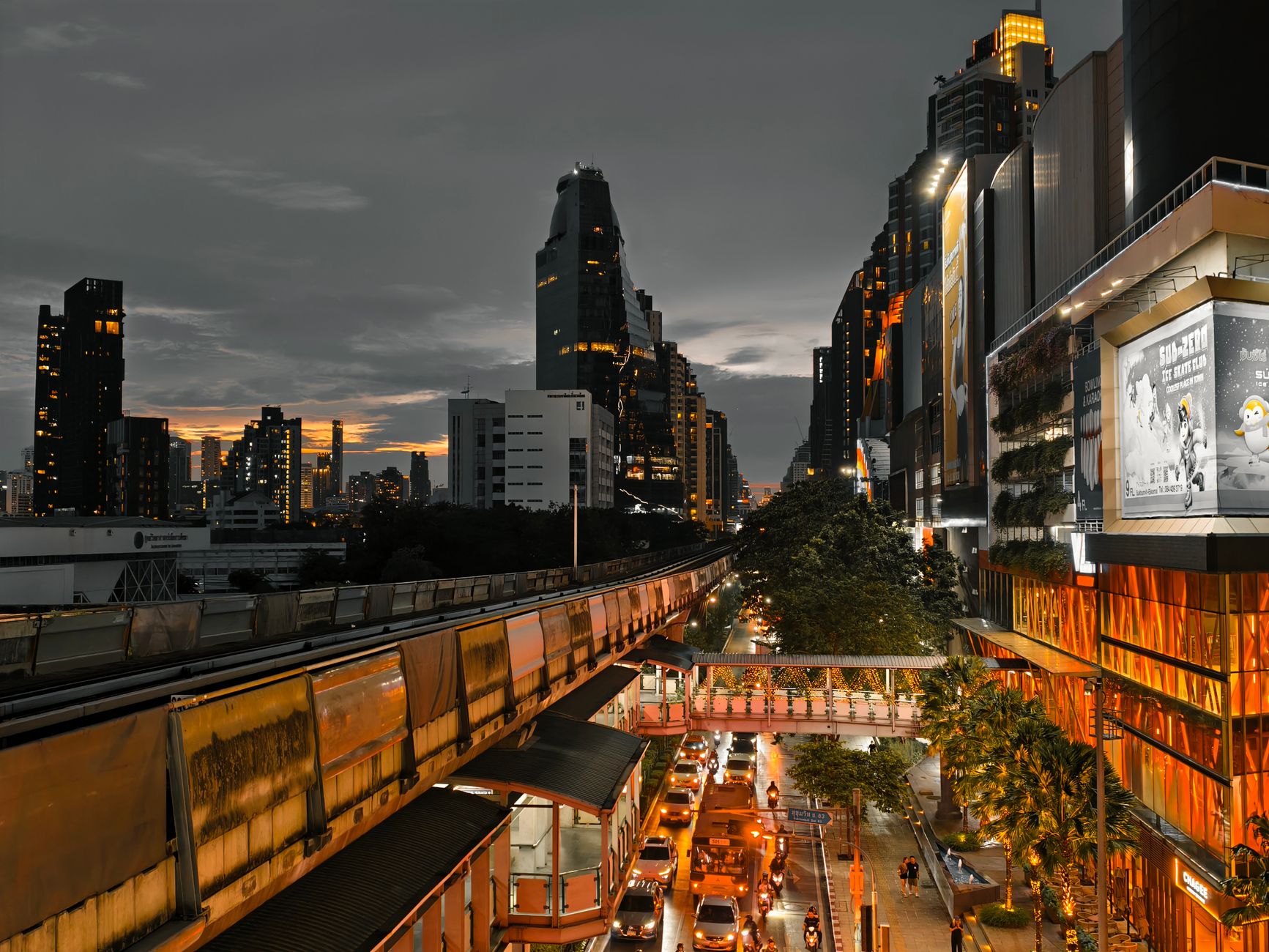 Cityscape at twilight showing busy traffic, skyscrapers, and an elevated train line in an urban setting. — Finding Balance an