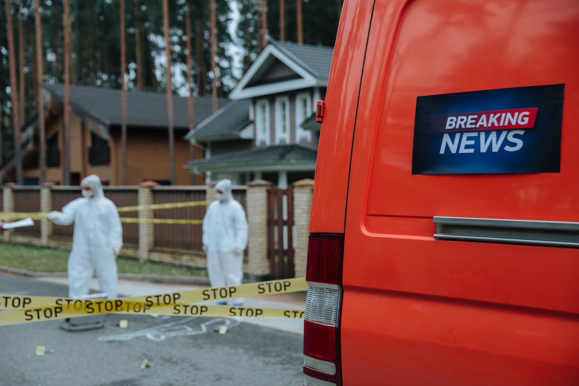 Forensic investigators in protective suits work at a marked-off crime scene near concrete houses. — Gain Instant Popularity w