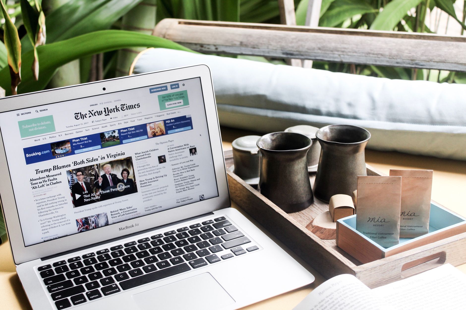 High angle of modern laptop with news on screen placed on table next to tin cups — Honour a loved person by naming a star