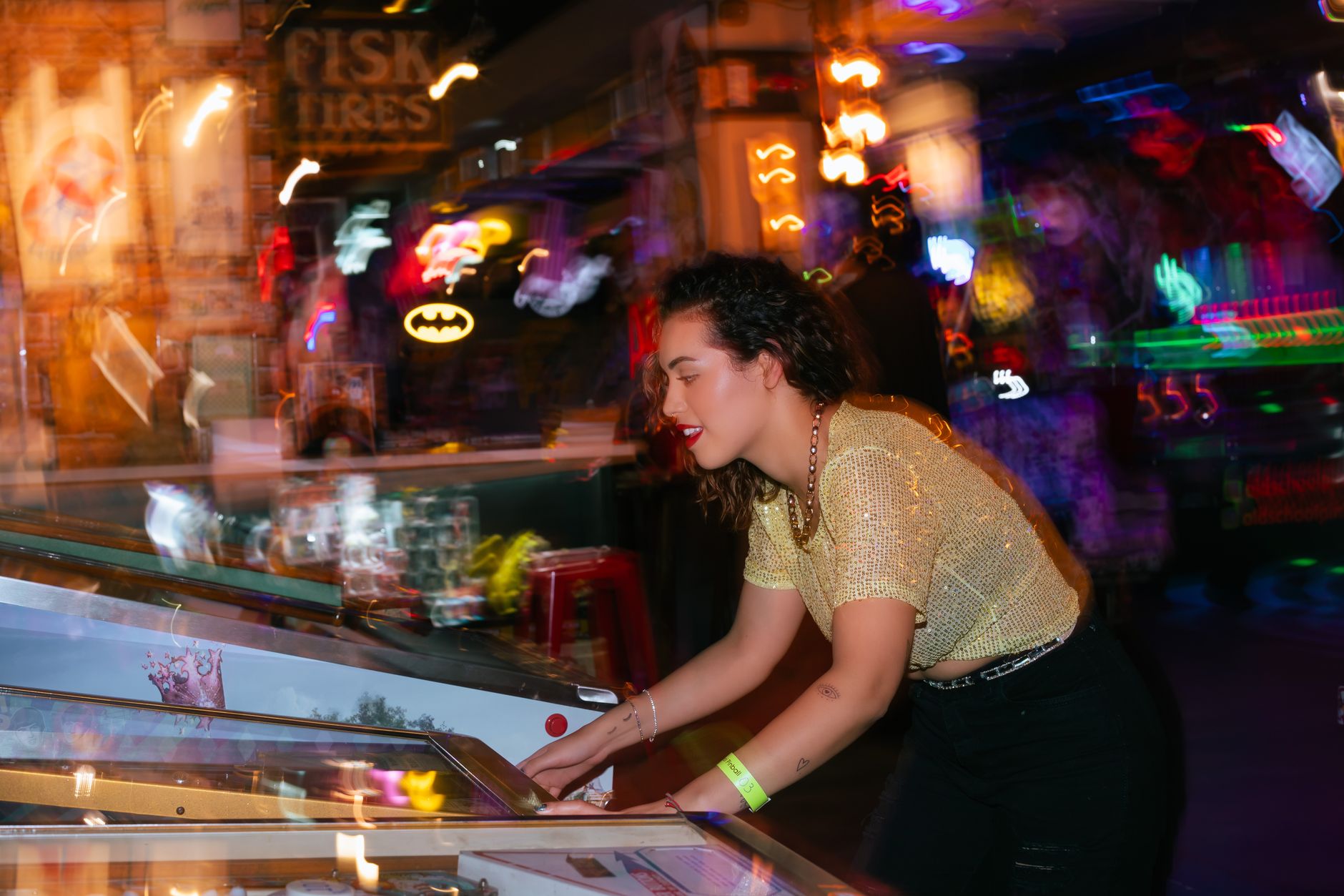 Young woman enjoying a night out playing pinball in an energetic arcade setting. — How do I know if an online casino is trust