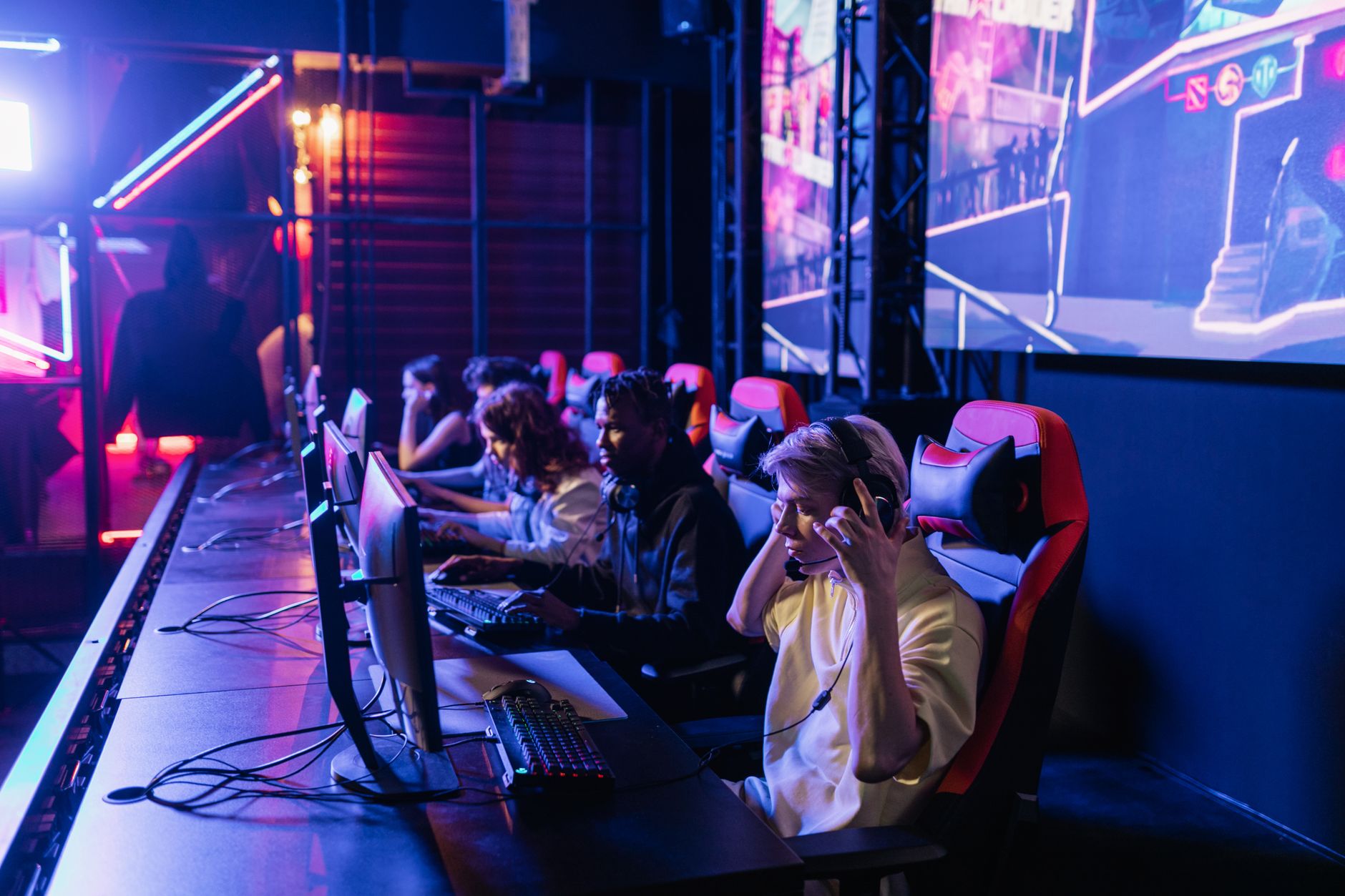 Focused gamers in a high-tech arena compete intensely, showcasing esports fervor. — How To Play PgSlotIn Your Email From Your