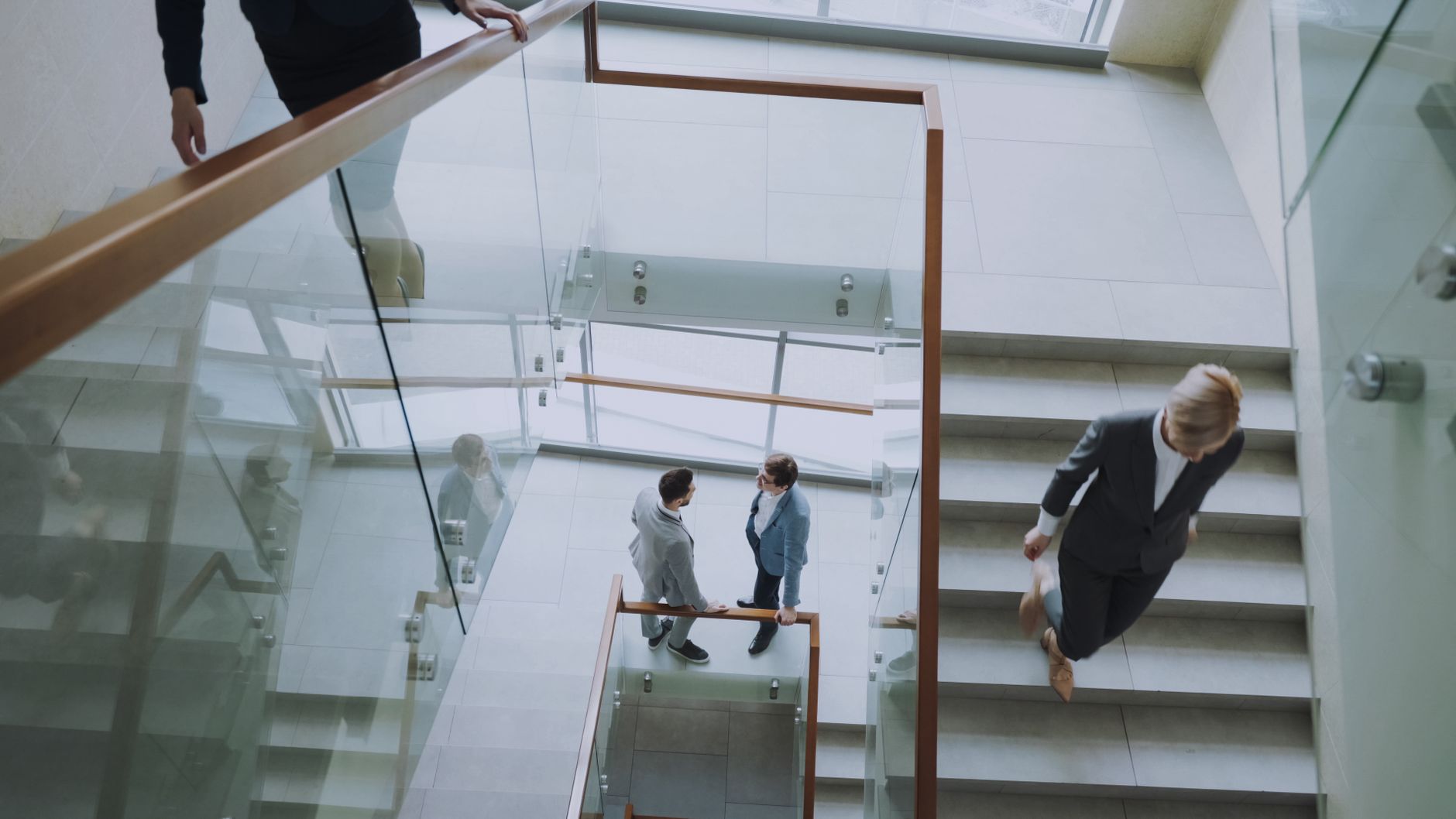Aerial view of professionals conversing in a glass staircase in a modern office. — Increasing Your Chances of Success With Wa