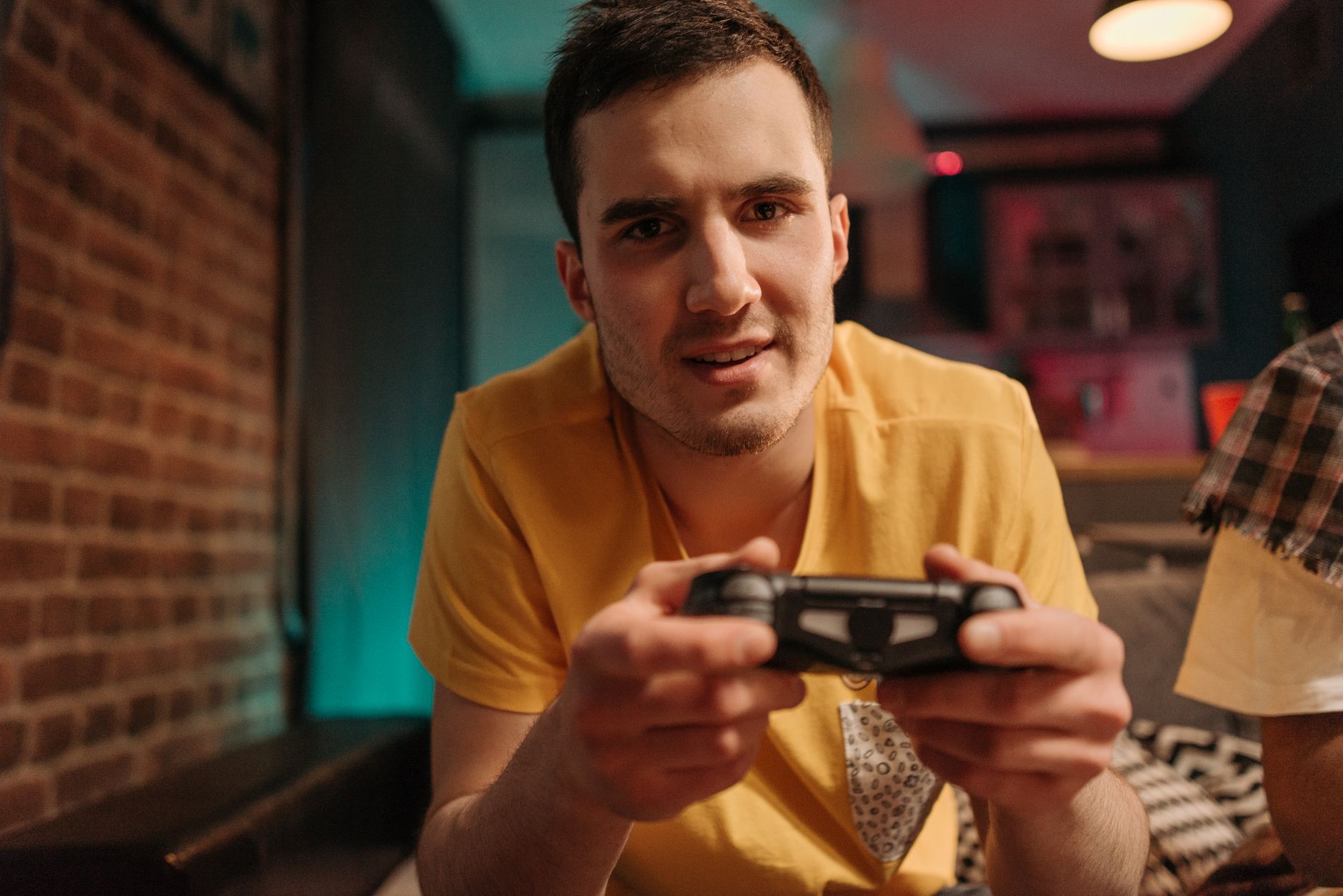 Focused young man enjoying video games with a controller indoors. — Online casinos offer a wide variety of incentives to thei