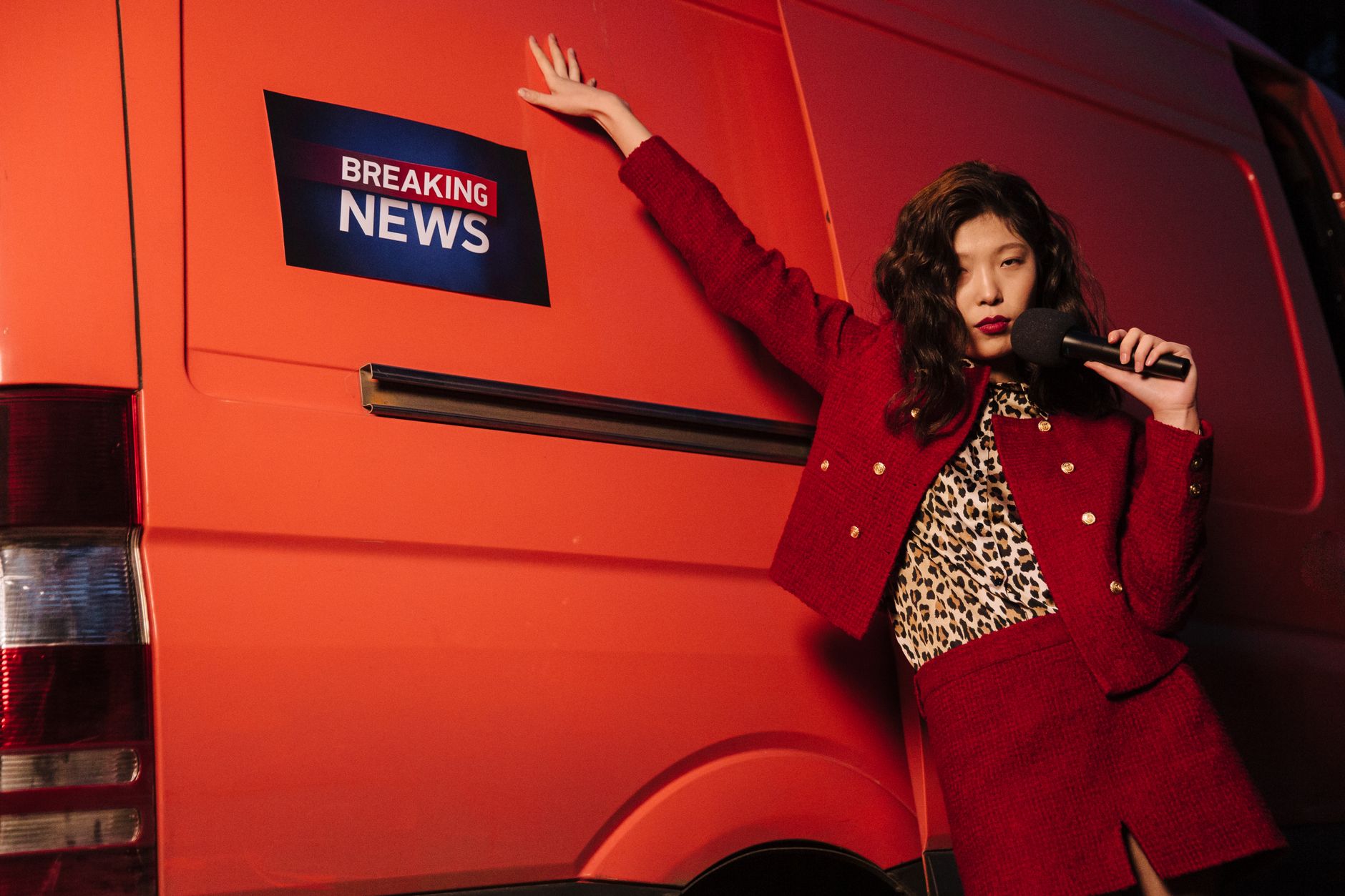 Fashionable reporter with microphone posing dramatically next to a news van. — THCA-Rich Cannabis: Navigating the Non-Psychoa