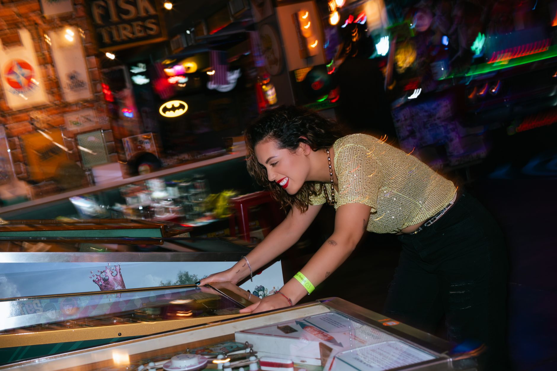 A woman cheerfully plays pinball in a vibrant, colorful arcade setting, embodying fun and entertainment. — Unheard Perks of P