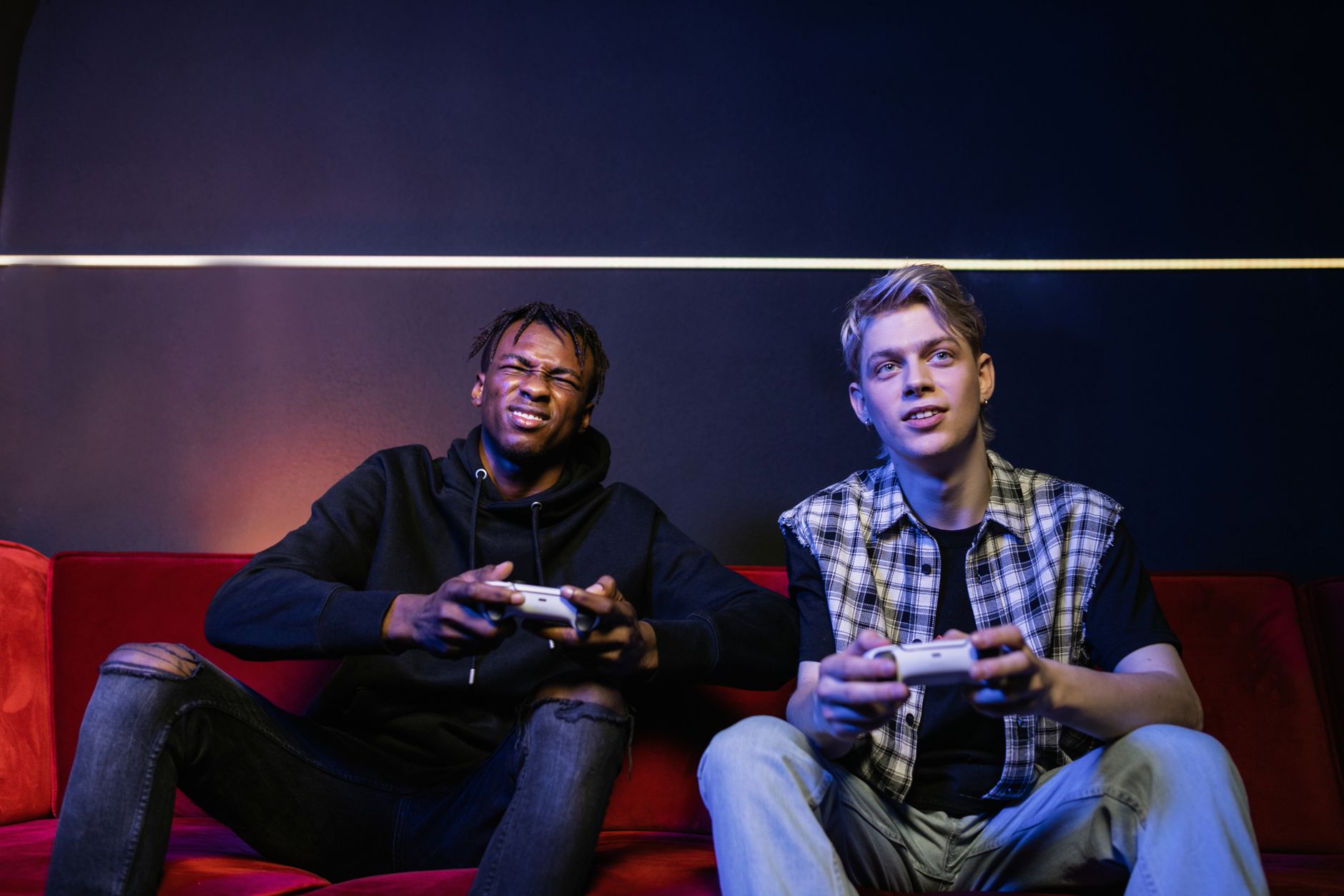 Two young men enjoying video games together on a couch, capturing leisure and friendship. — Unveiling the Lsm99 Casino Fronti