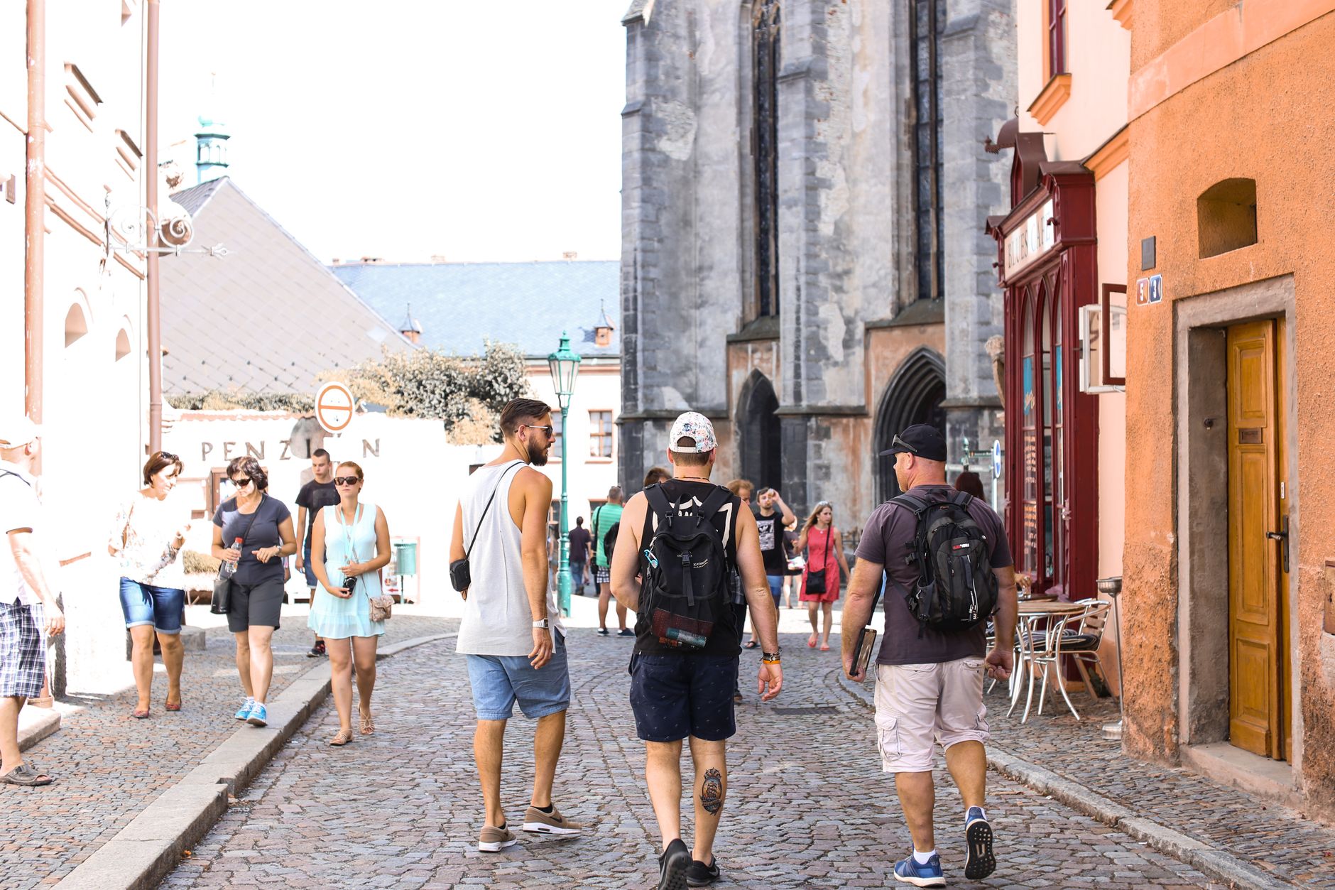 A bustling stone road in a historic European city filled with tourists enjoying a summer day. — What you ought to Learn About